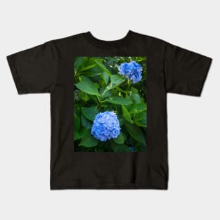 Fresh blue hydrangea flowers and bush Kids T-Shirt